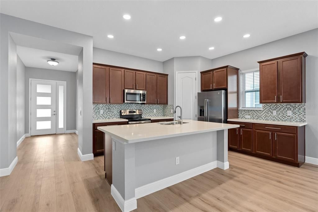 Open floor plan with kitchen, dining and living room