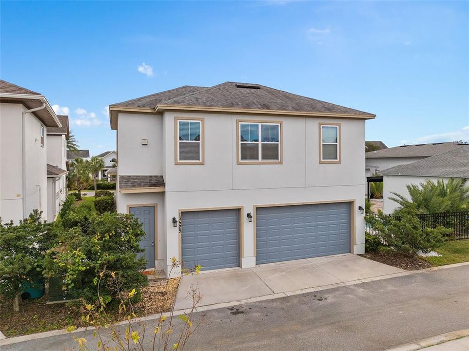 View of home from rear with 3 garages and garage apartment rear entrance