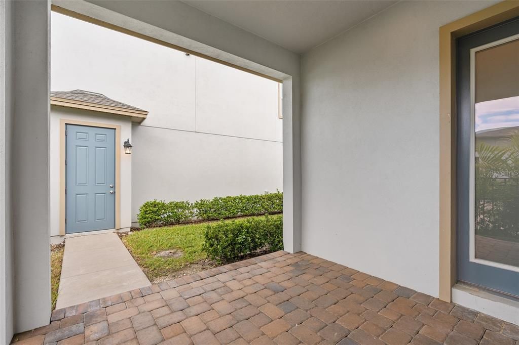 Covered Back porch leading to detached garage