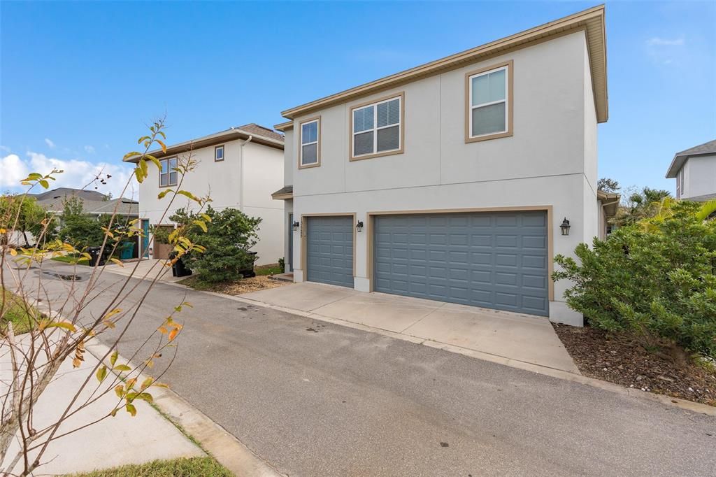 View of home from rear with 3 garages and garage apartment rear entrance