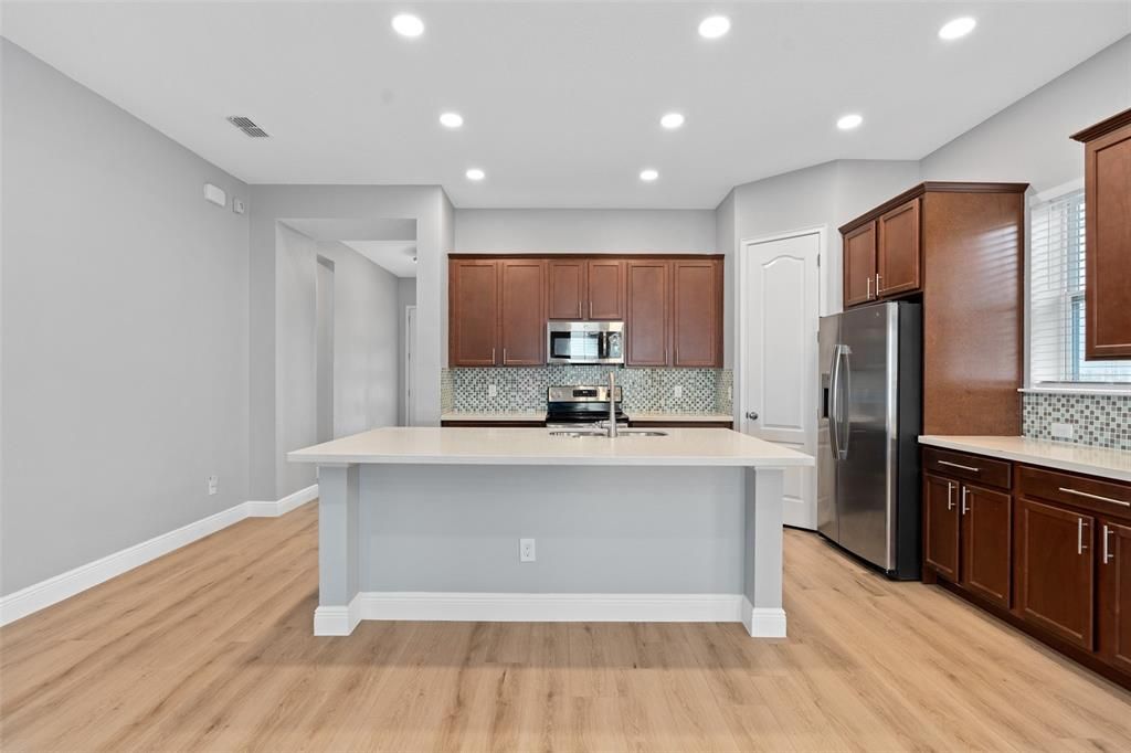 Open floor plan with kitchen, dining and living room