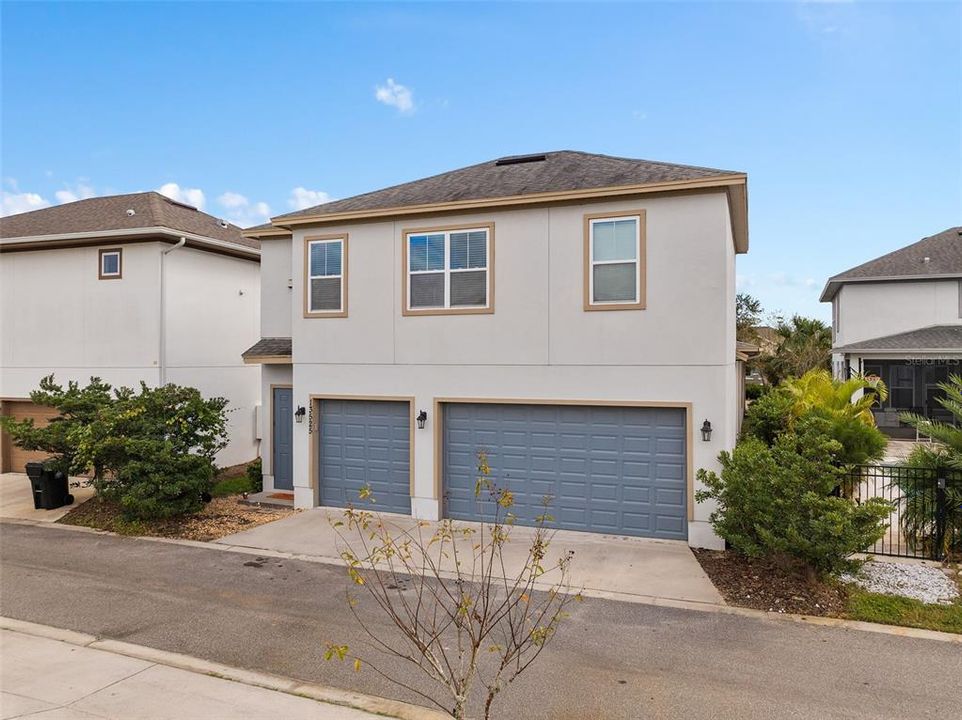 View of home from rear with 3 garages and garage apartment rear entrance