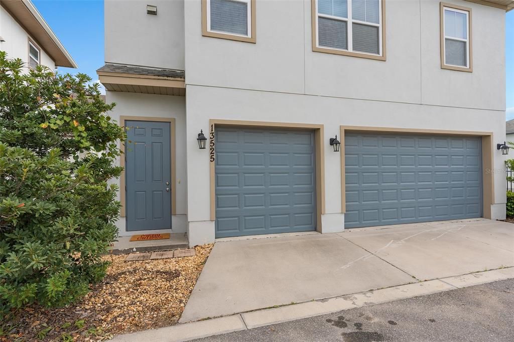 View of home from rear with 3 garages and garage apartment rear entrance