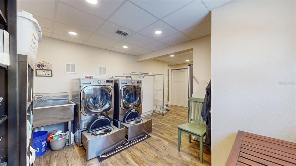 Laundry showing included XL Washer, 2 mini Washers & XL Dryer & Stainless Sink