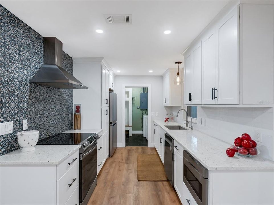 The kitchen is well appointed with, Stainless appliances, quartz/solid surface countertops, and stunning cabinetry. Just to the end of the kitchen is the indoor laundry room & entry into the spacious two car garage