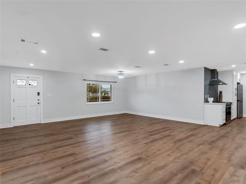 This view features the homes wide open space and entrance into the galley kitchen.