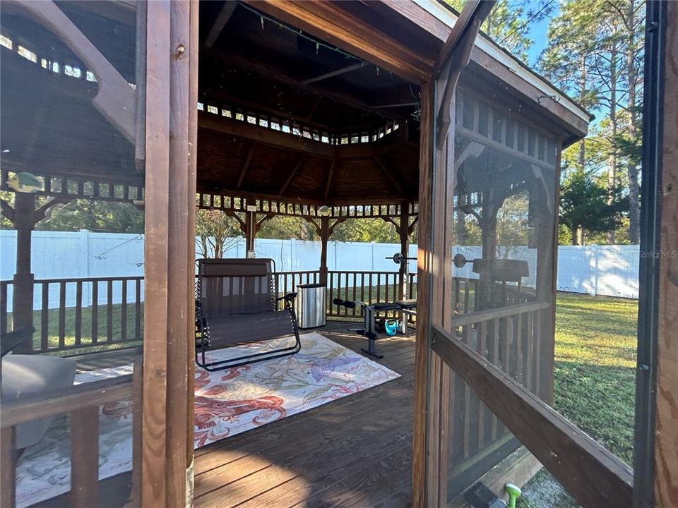 Screened-in wooden Gazebo to enjoy the outside without the bugs