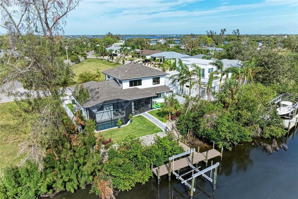 Back of home with dock and boat lift