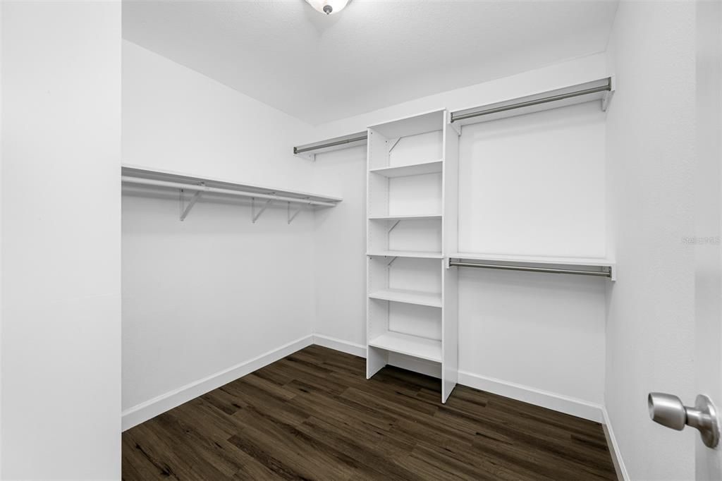 Primary bedroom walk-in closet