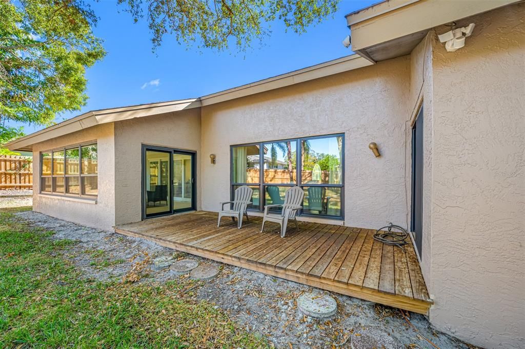 Close up of rear wood deck accessed from Florida room (left, pictured) and primary bedroom (right, not pictured)