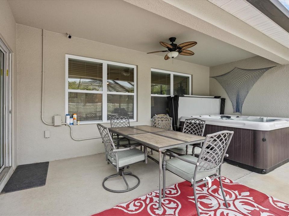 Covered and screened in patio with hot tub