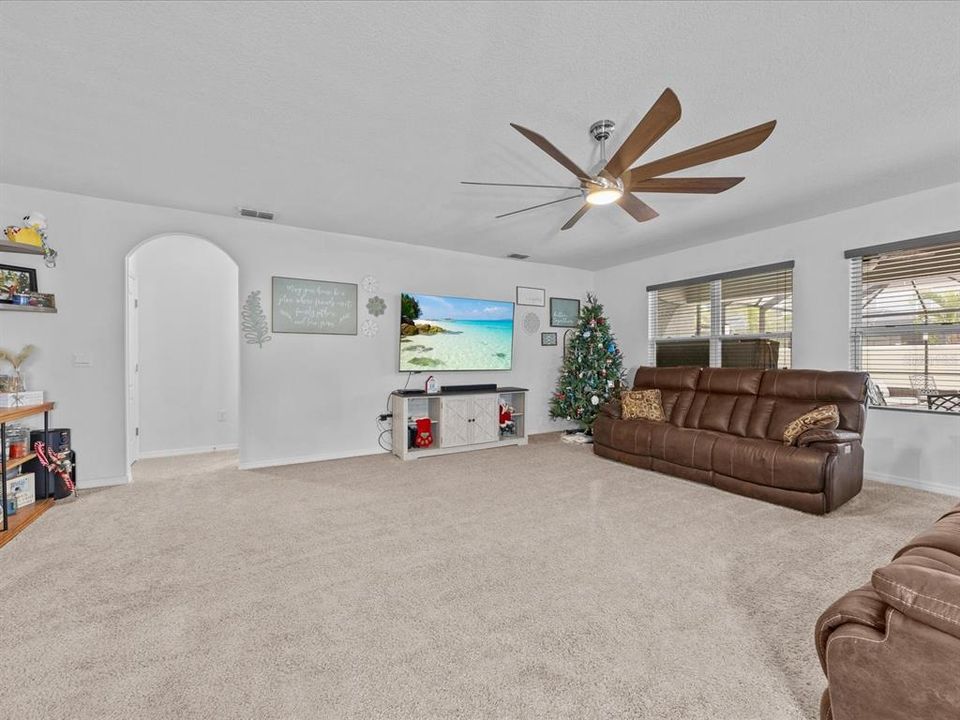 Living room with view into back screened in patio