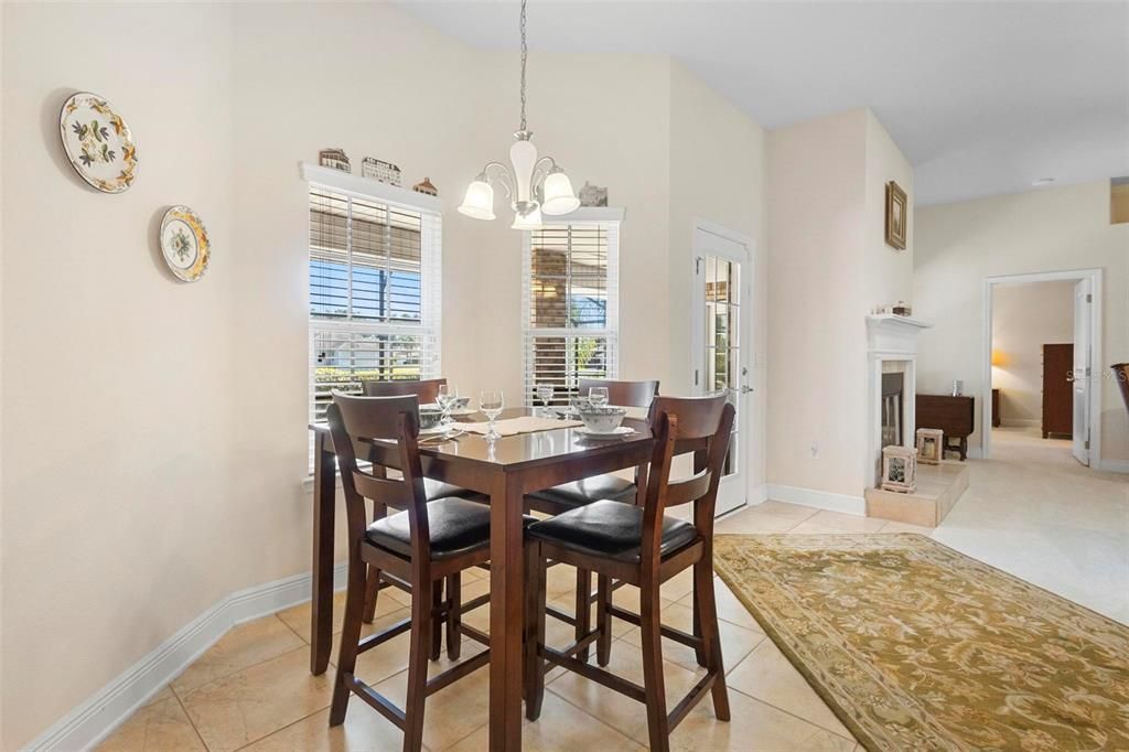 Rear dining area. Primary suite afar beyond fireplace.