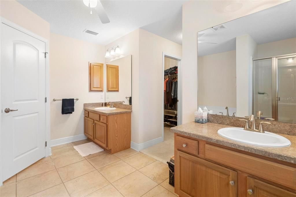 The huge ensuite bath has dual vanities.