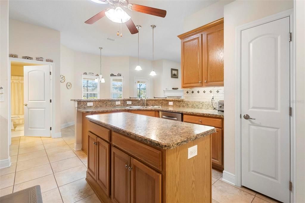 Large island in kitchen across from closet pantry.