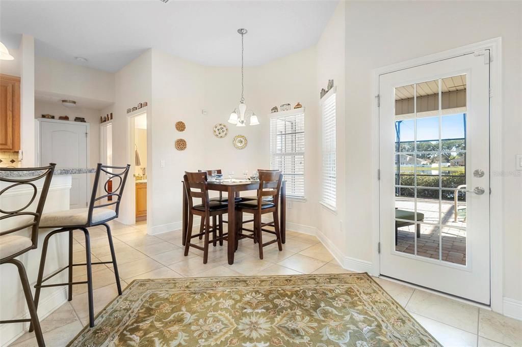 Rear dining area. Kitchen at left, lanai/pool area at right.