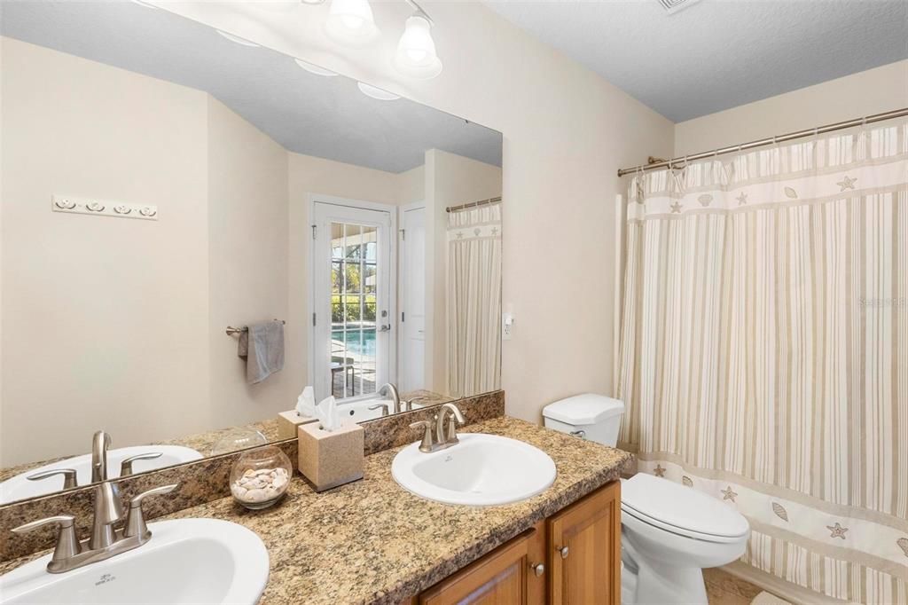 Full bath near bedrooms #3 and #4 have private access to lanai and pool area.