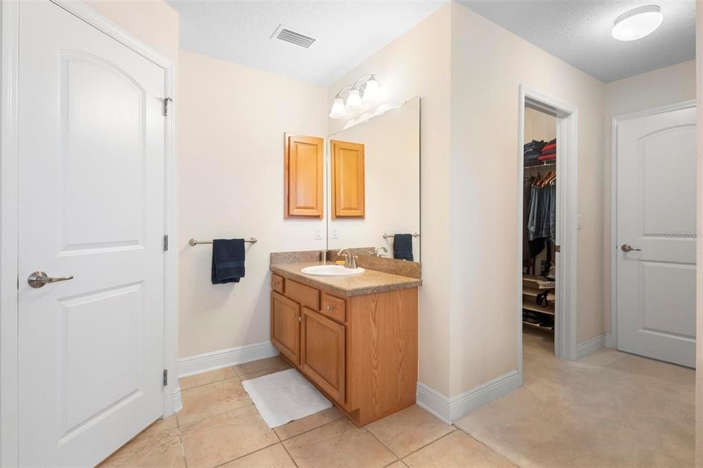 Primary ensuite bath. Water closet at left. Walk-in closet at right.