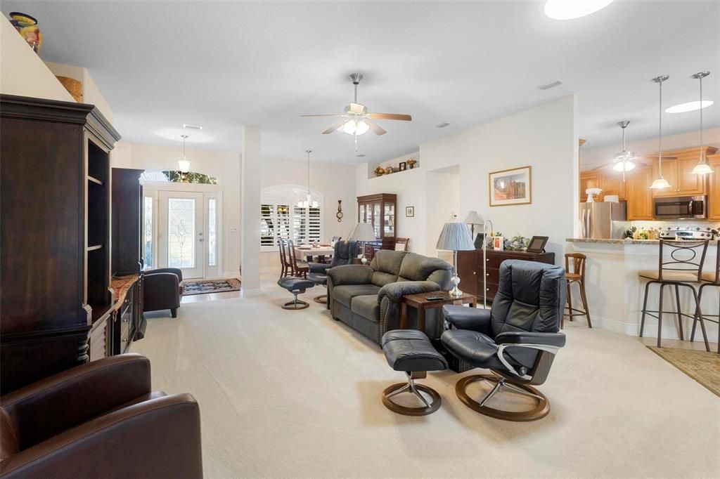 Main living area towards front door and kitchen (right).