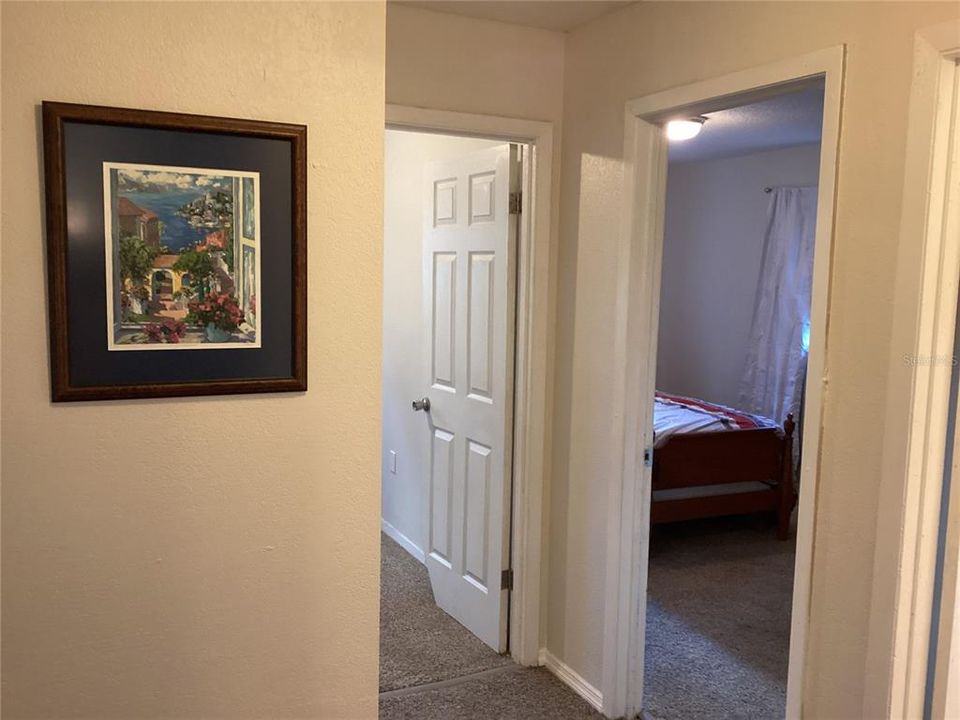 Hallway with bedrooms to the right and the master suite to the left.