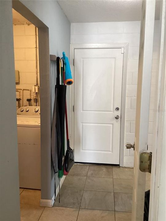 Back door with laundry room on the left and kitchen on the right.