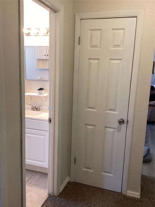 One of two hall closets with full bath on the left.