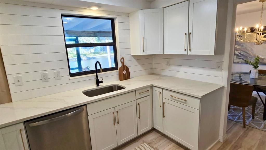 Updated kitchen with new appliances, cabinets, and quartz counters