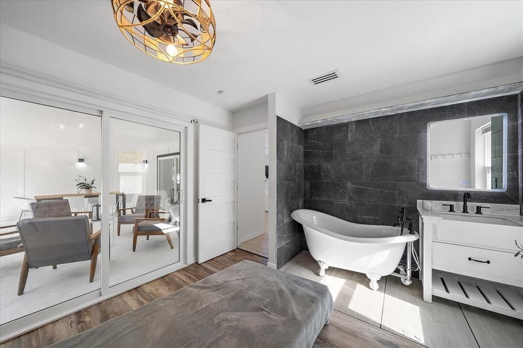 Bedroom 3 with claw foot tub and vanity sink