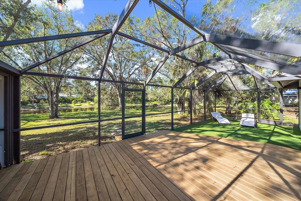 Screened in back patio with turf