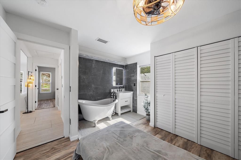 Bedroom 3 with claw foot tub and vanity sink