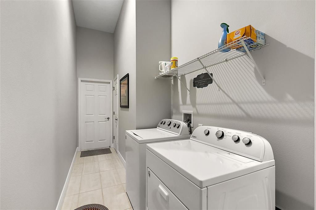 Inside laundry room is located as a pass through between garage entry and kitchen area