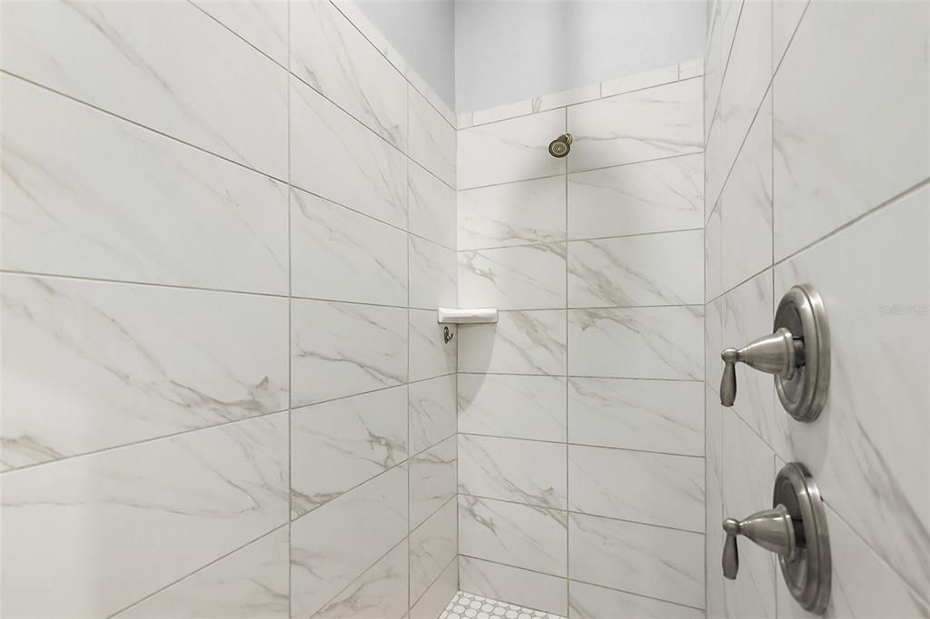 Tiled walk-in shower with rain shower head!