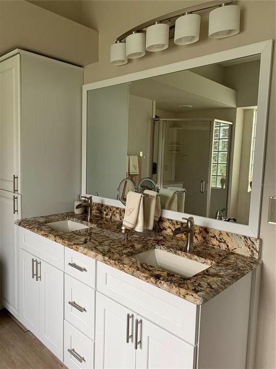 Double sinks in master bath.  Updated lighting, mirror, and cabinets