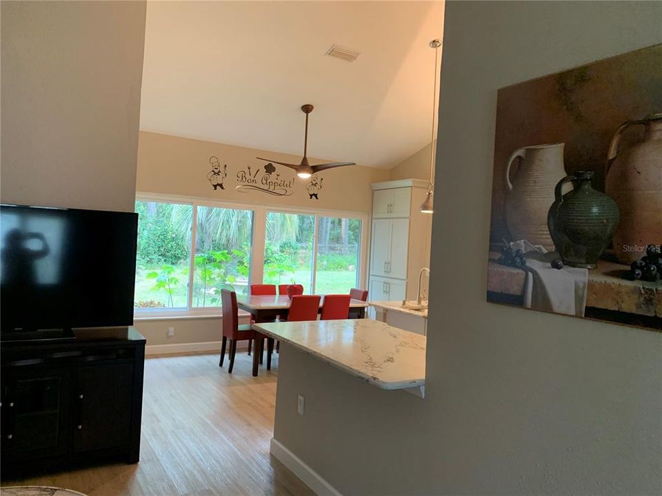 Looking from living room into kitchen eating area with built ins