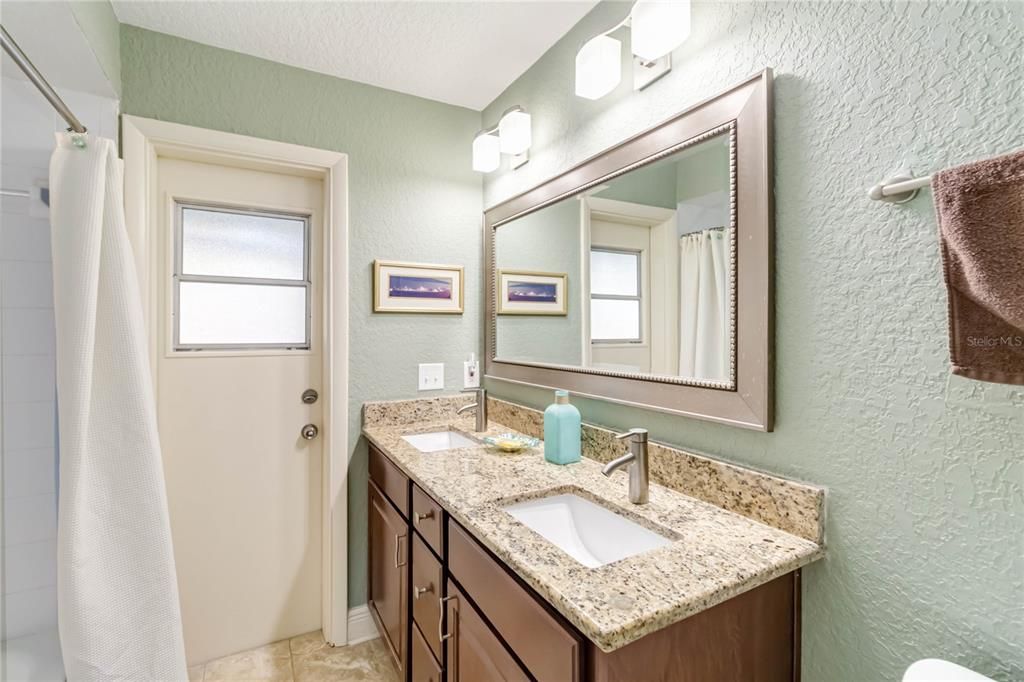 Guest bath with pool access door.