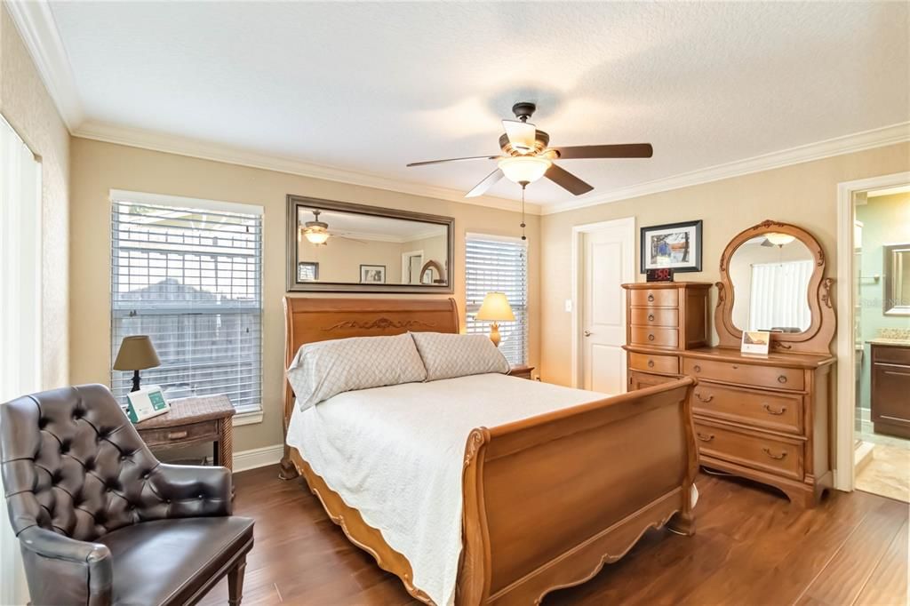 Primary bedroom with crown molding.