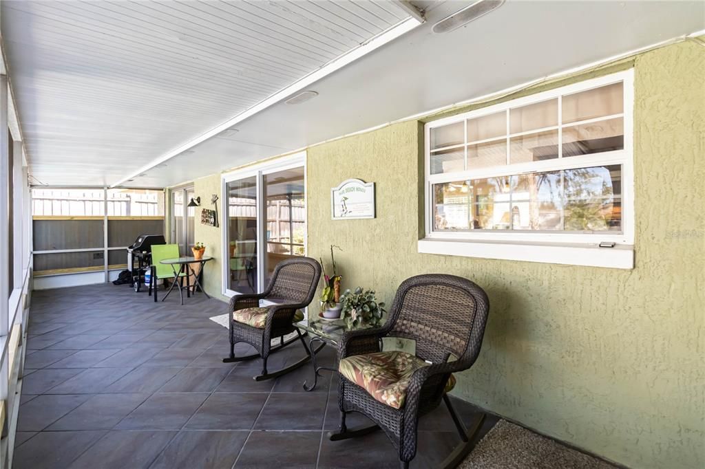 Large relaxing screened in patio overlooking the pool.