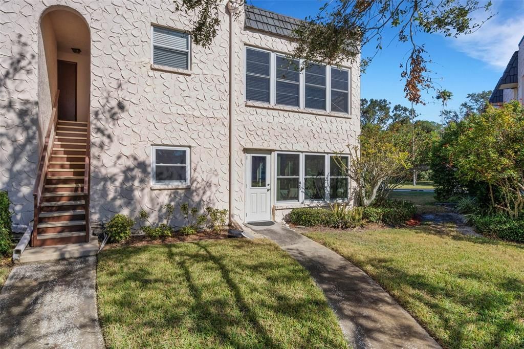 Rear of Unit With Pedestrian Door From FL Room and Walkway To Pool/Clubhouse Area