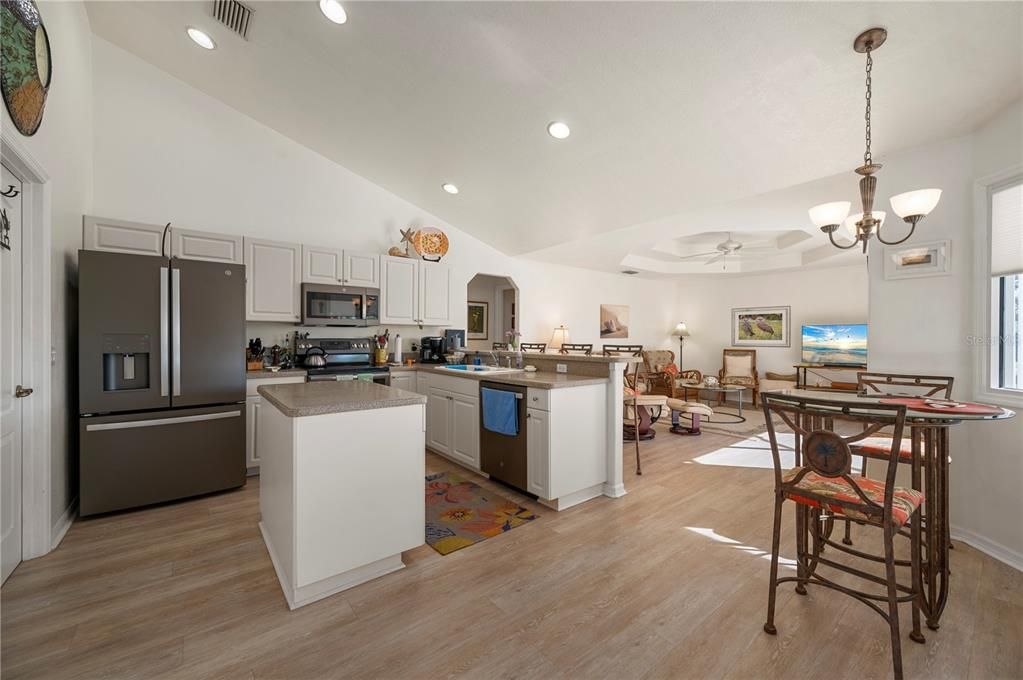 Kitchen features an Island, Corian counters