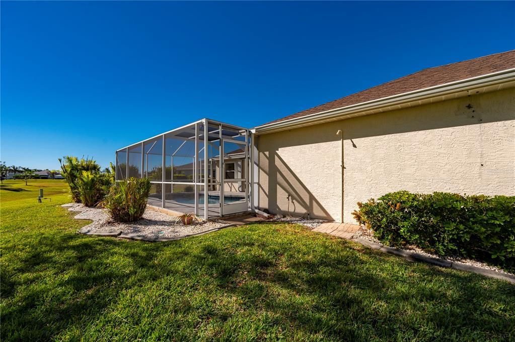 Rear of home and pool area, curbed and stone landscaping