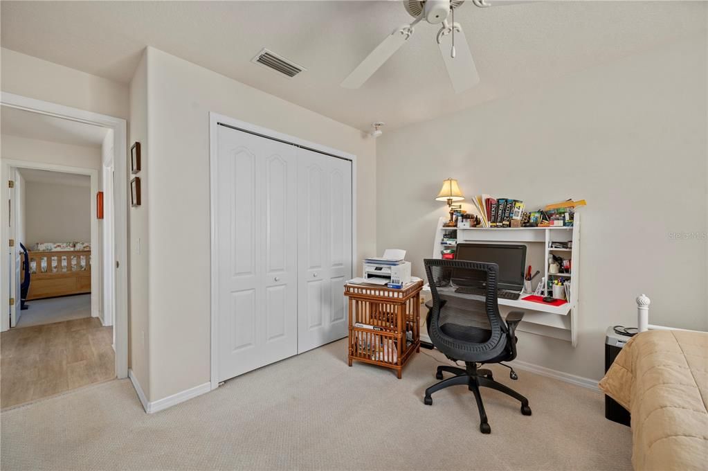 Full-sized closet, berber carpet and ceiling fan