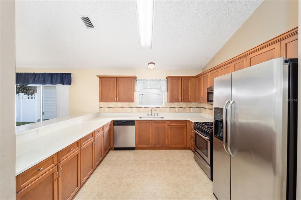 Ample cabinetry are beneath the quarts counter.