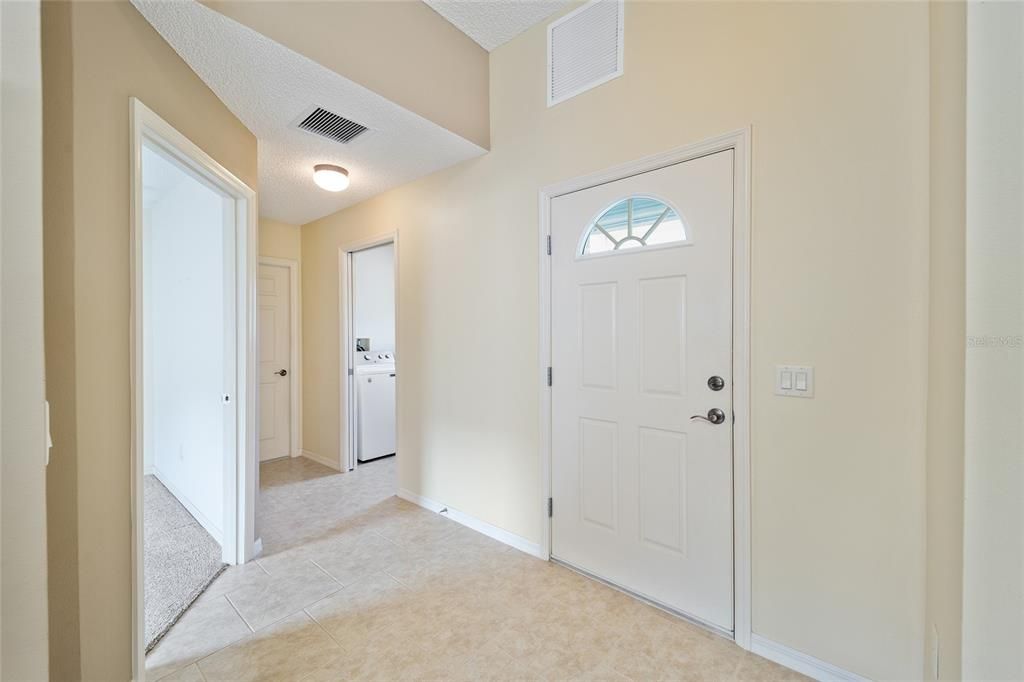 Looking toward the laundry room and garage from the hall.