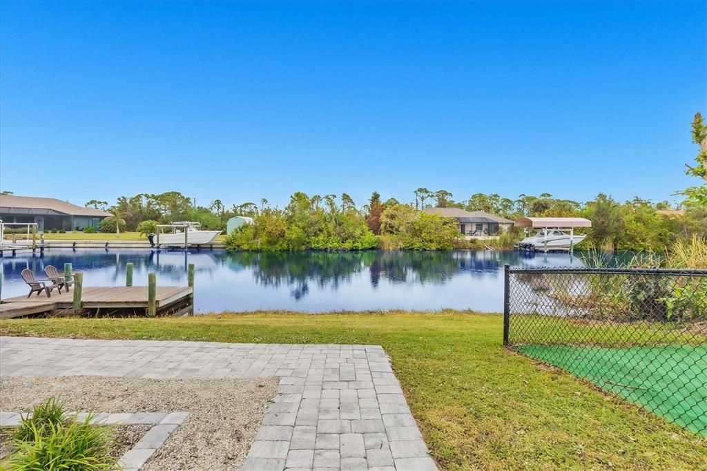 Stroll Down the Charming Paver Sidewalk to your Serene Dock for Morning Sunrises