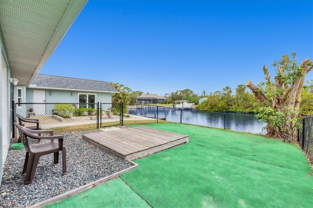 Expansive Fenced Artificial Turf Area Perfect for your Furry Friends to Play and Roam