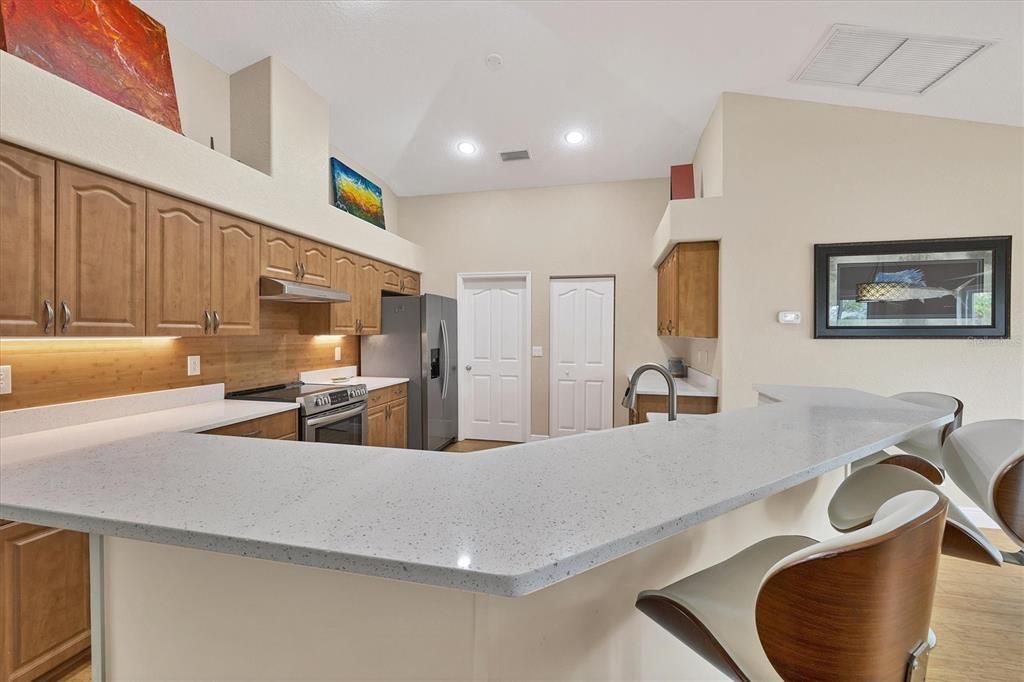 Spacious Kitchen Featuring Built-in Pantry and Laundry Access