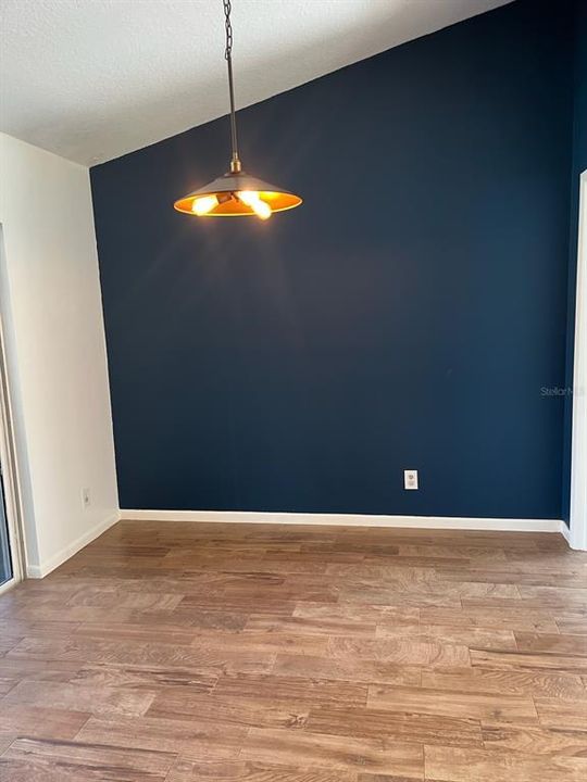 Dining Area with vaulted tall ceiling