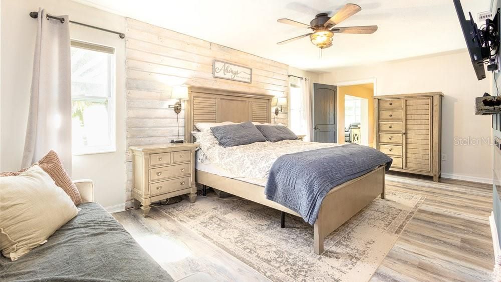 Master Bedroom with a fireplace and barndoors