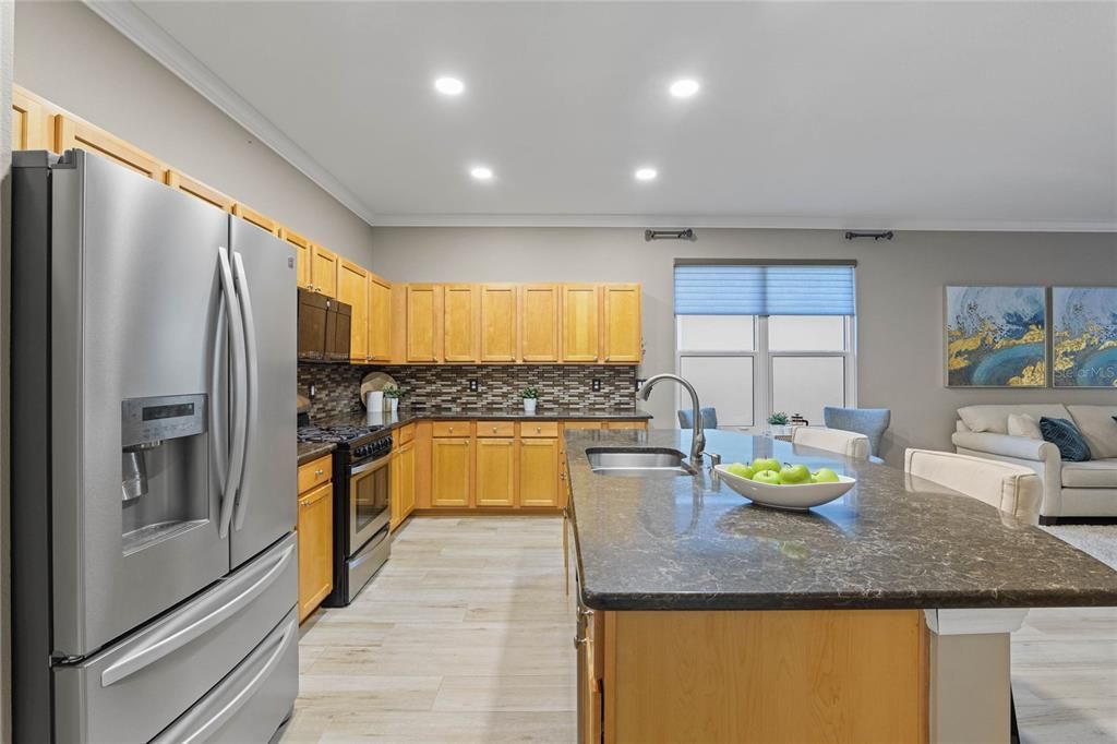 Kitchen w/ stainless steel appliances, Pull-out shelving & Listello backsplash