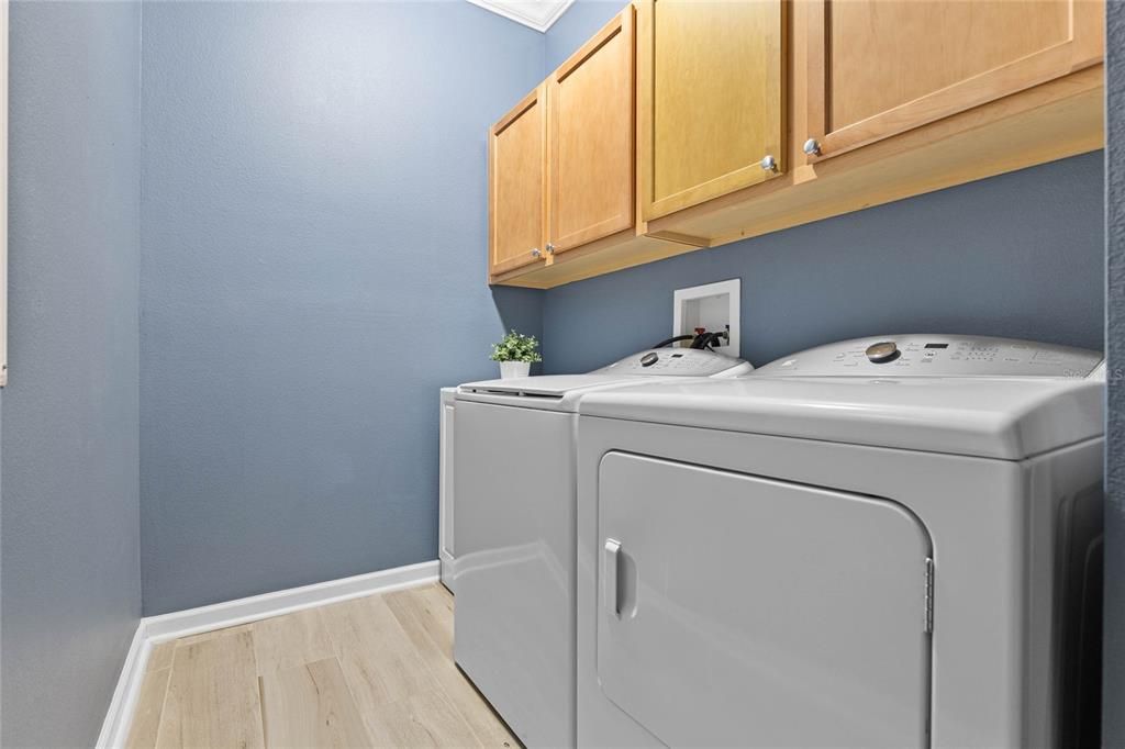 5'6" x 7'6" Laundry Room w/ storage cabinets, electric dryer & a natural gas connection for the future